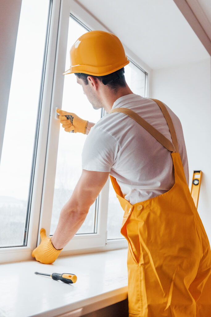 Professional installs a new window to improve energy efficiency and comfort.